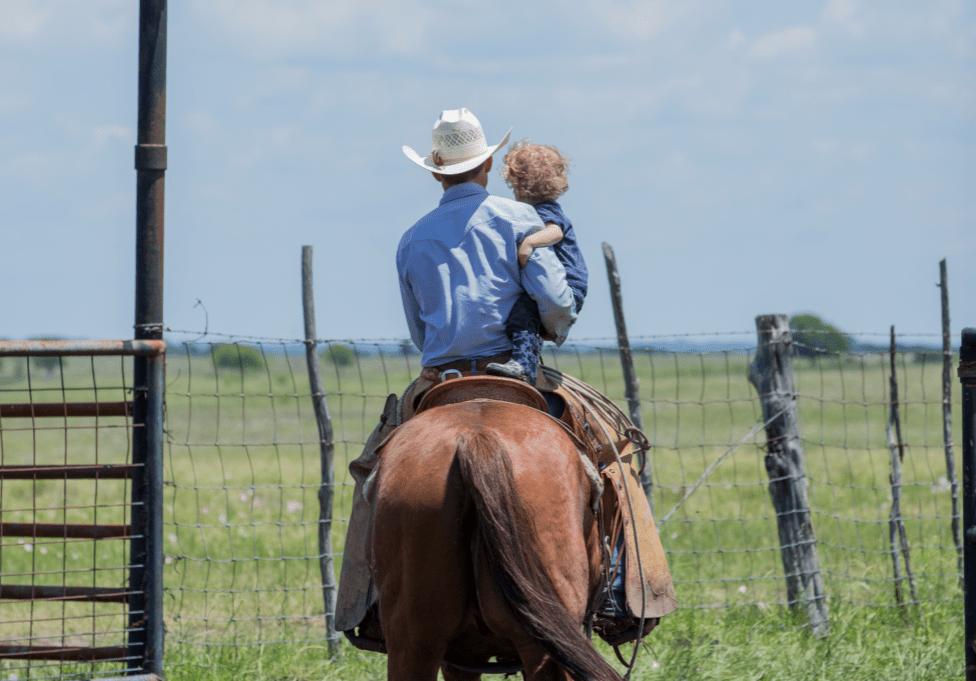 Father and son riding a horse